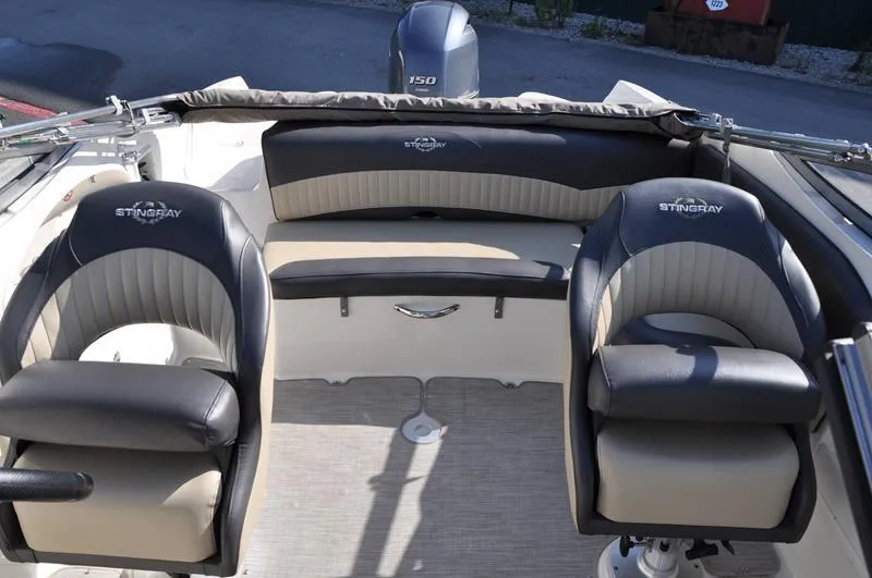 Slide: The Image of 2018 Stingray 214 LR boat interior with dual seats and rear bench. - 10