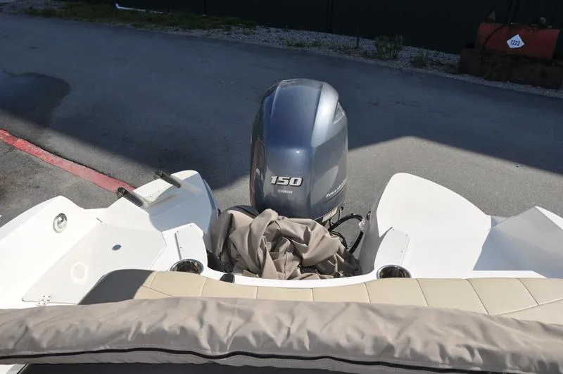 Slide: The Image of 2018 Stingray 214 LR boat with a 150 horsepower outboard motor, rear view. - 13