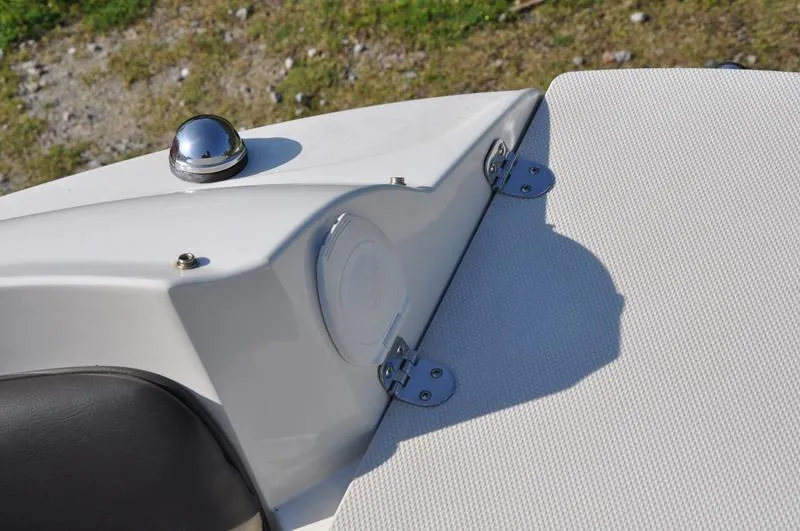 Slide: The Image of 2018 Stingray 214 LR boat detail, featuring sleek white design and chrome accents. - 22