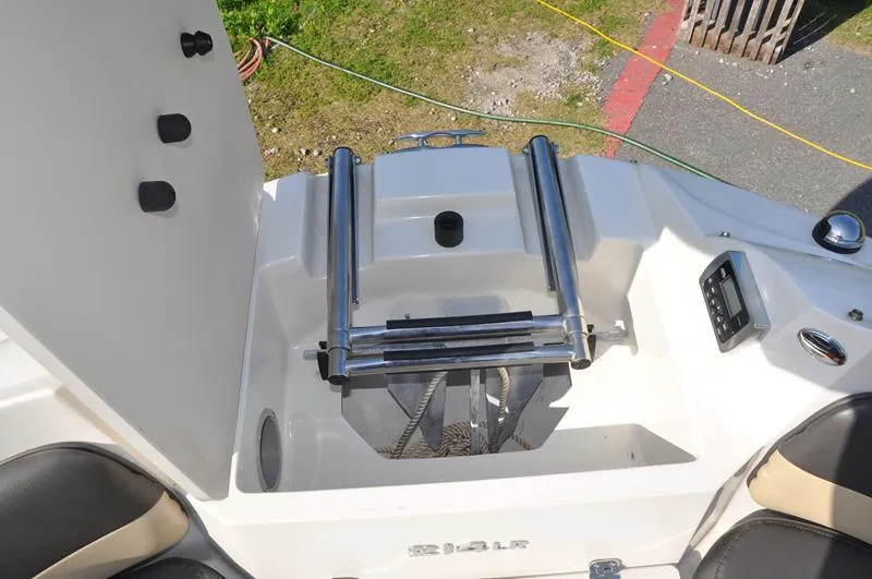 Slide: The Image of 2018 Stingray 214 LR boat with swim platform and ladder, featuring sleek design and comfortable seating. - 23