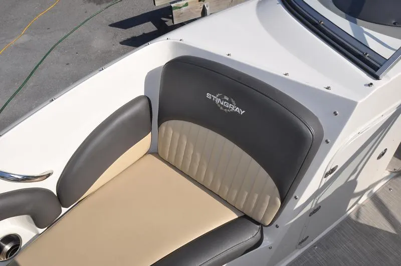 Slide: The Image of 2018 Stingray 214 LR boat seat with beige and black upholstery. - 25