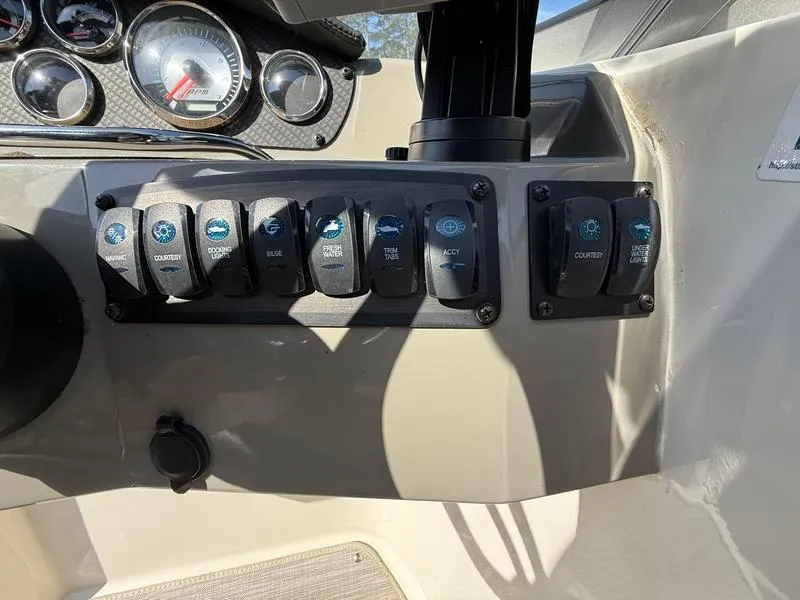 Slide: The Image of Control panel of a 2018 Stingray 214 LR boat with switches and gauges. - 30