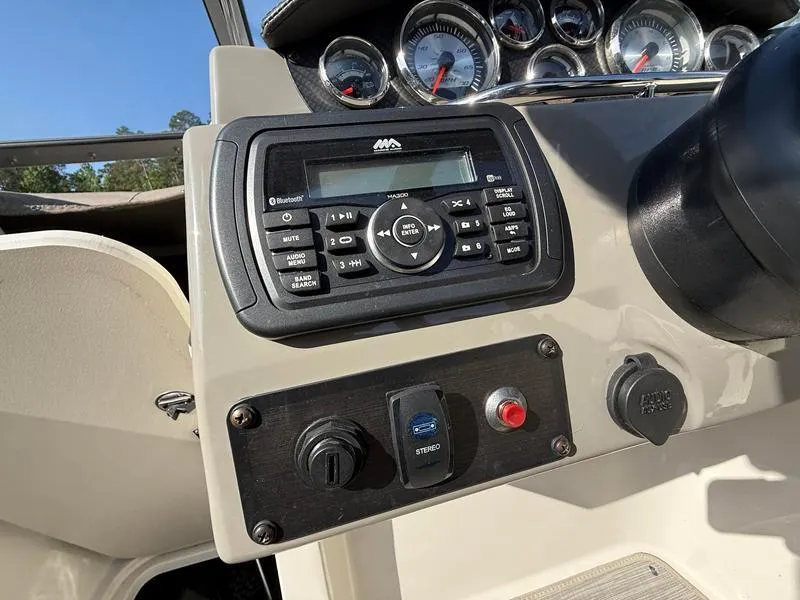 Slide: The Image of Control panel of a 2018 Stingray 214 LR boat with stereo system and gauges. - 31
