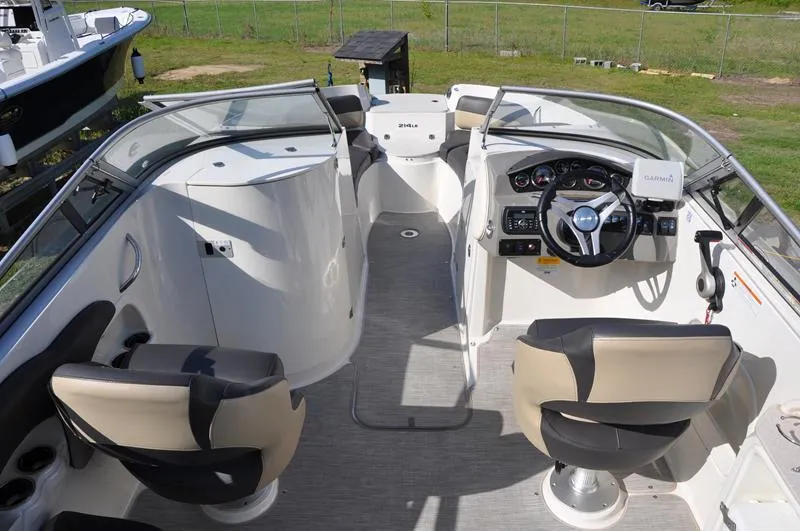 Slide: The Image of 2018 Stingray 214 LR boat interior with dual seats and steering console. - 9