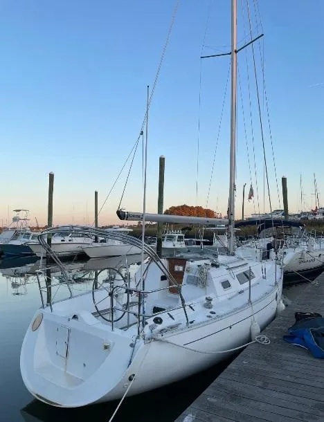 Slide: The Image of 1990 Beneteau First 285 sailboat docked at marina during sunset. - 4