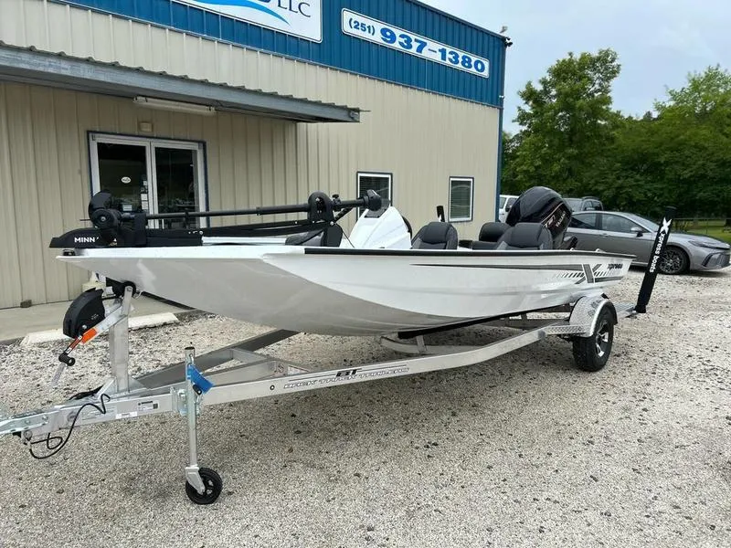 Slide: The Image of 2025 Xpress H18 Bass boat on trailer outside dealership. - 1