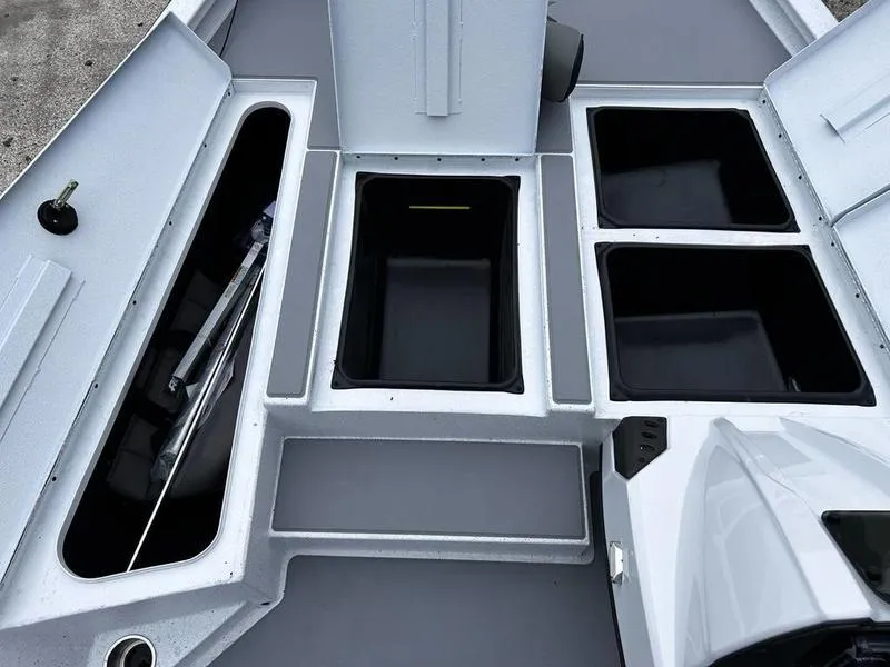 Slide: The Image of 2025 Xpress H18 Bass boat storage compartments, featuring multiple open hatches and organized layout. - 10