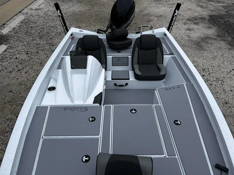 Slide: The Image of 2025 Xpress H18 Bass boat interior with gray seating and storage compartments. - 11