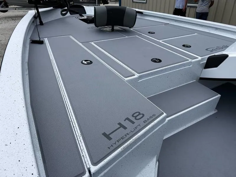 Slide: The Image of 2025 Xpress H18 Bass boat deck with sleek gray design and storage compartments. - 12