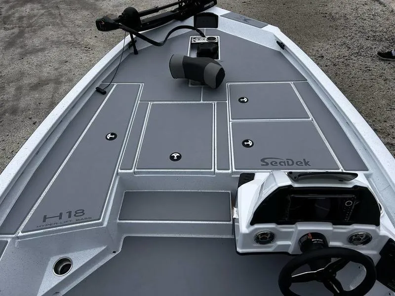 Slide: The Image of 2025 Xpress H18 Bass boat deck with SeaDek flooring and steering console. - 13