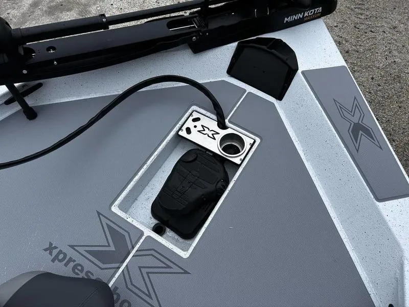 Slide: The Image of 2025 Xpress H18 Bass boat deck with Minn Kota trolling motor and control panel. - 17