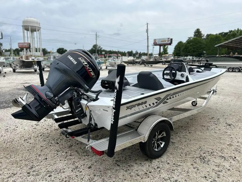 Slide: The Image of 2025 Xpress H18 Bass boat with Yamaha engine on a trailer in a boatyard. - 3