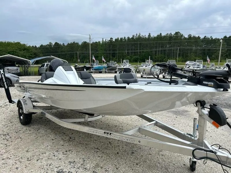 Slide: The Image of 2025 Xpress H18 Bass boat on trailer, parked outdoors, with overcast sky. - 6