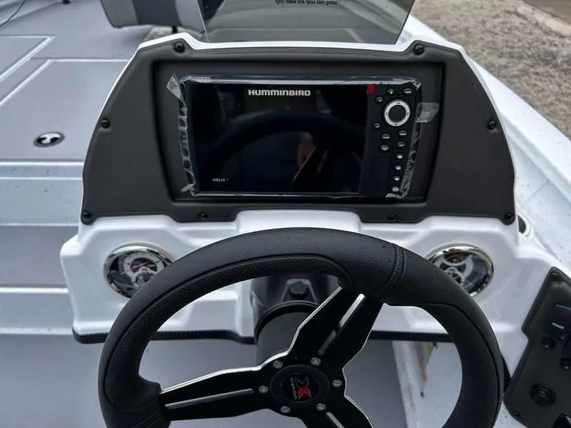 Slide: The Image of 2025 Xpress H18 Bass boat dashboard with Humminbird navigation system and steering wheel. - 9