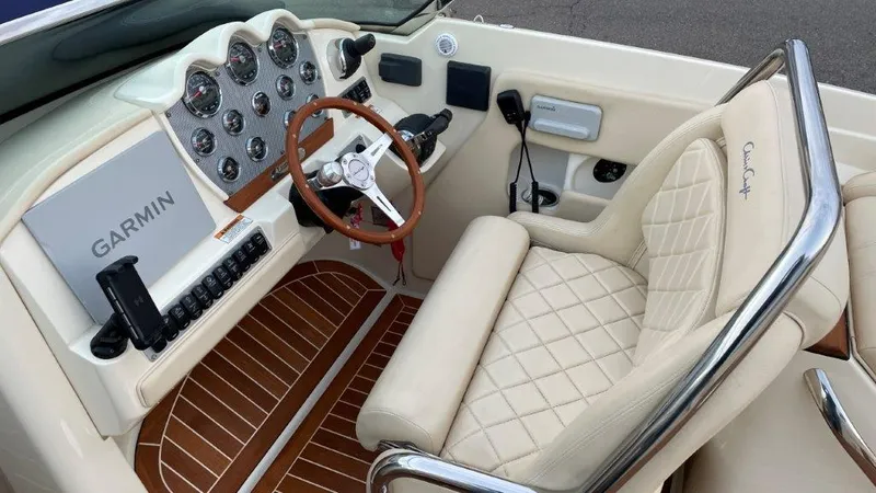 Slide: The Image of 2017 Chris-Craft Launch 28 cockpit with Garmin navigation, luxurious seating, and classic wood accents. - 12