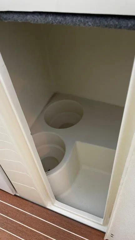 Slide: The Image of 2017 Chris-Craft Launch 28 storage compartment with cup holders, featuring a sleek interior design. - 16