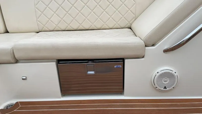 Slide: The Image of Luxurious seating and storage on 2017 Chris-Craft Launch 28 boat, featuring quilted upholstery. - 17