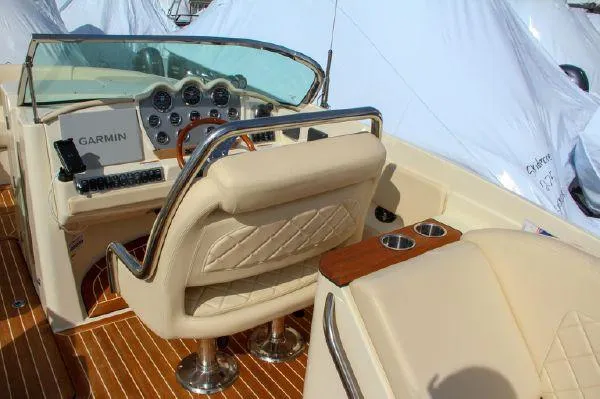 Slide: The Image of 2017 Chris-Craft Launch 28 boat interior with Garmin navigation, luxurious seating, and wood accents. - 6