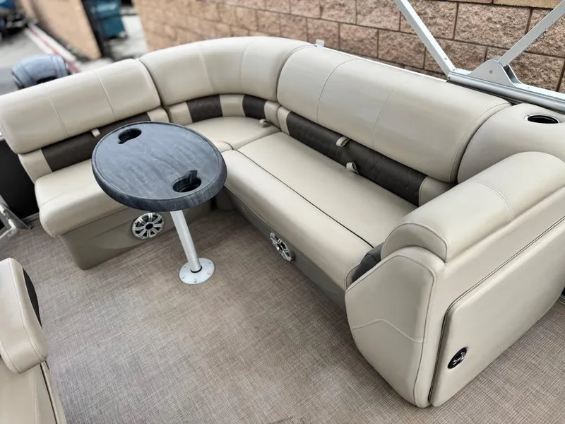 Slide: The Image of 2023 Sun Tracker Party Barge 20 DLX with beige seating and round table. - 12