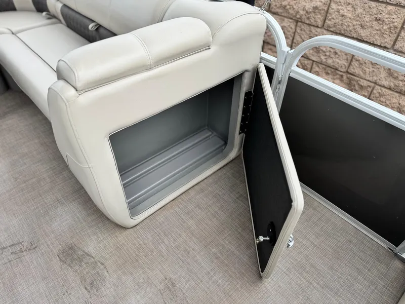 Slide: The Image of 2023 Sun Tracker Party Barge 20 DLX storage compartment with open door on boat deck. - 14