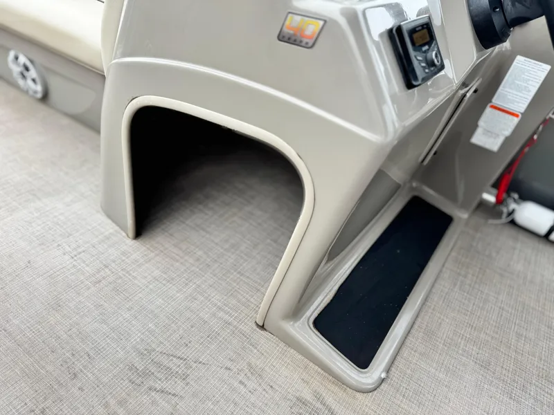 Slide: The Image of 2023 Sun Tracker Party Barge 20 DLX console detail with beige interior. - 17