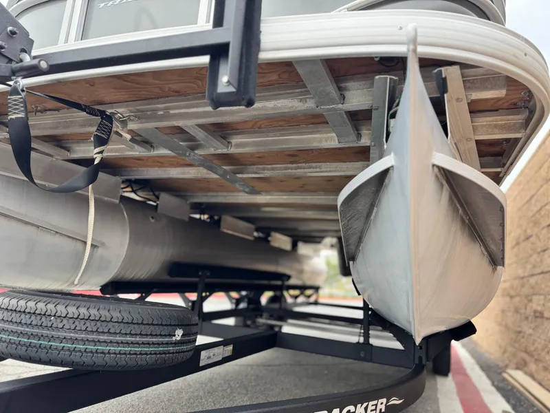 Slide: The Image of 2023 Sun Tracker Party Barge 20 DLX pontoon boat on trailer, underside view. - 3