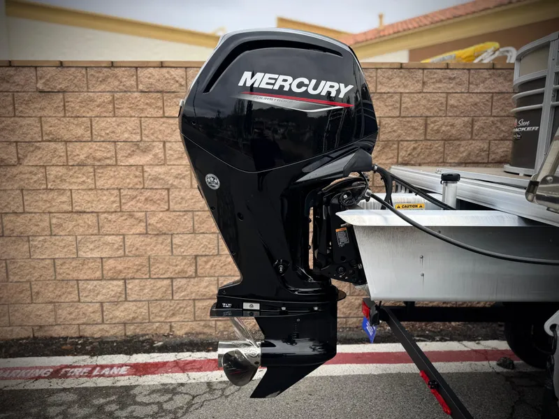 Slide: The Image of 2023 Sun Tracker Party Barge 20 DLX with Mercury outboard motor, parked on a street. - 6