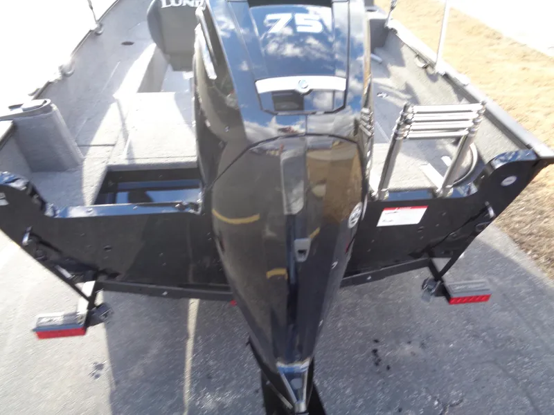 Slide: The Image of 2025 Lund 1650 Rebel XL SS boat with powerful outboard motor, rear view. - 10