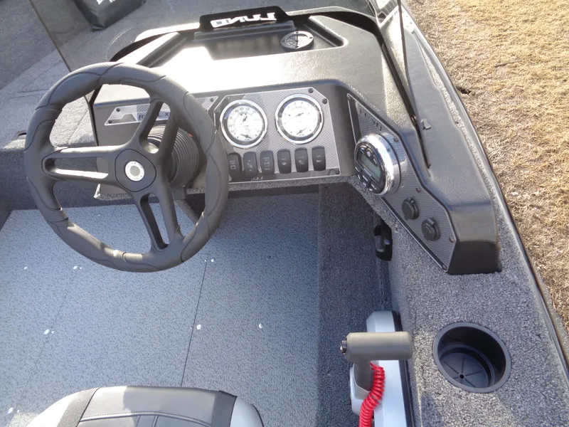 Slide: The Image of 2025 Lund 1650 Rebel XL SS boat dashboard with steering wheel and gauges. - 12