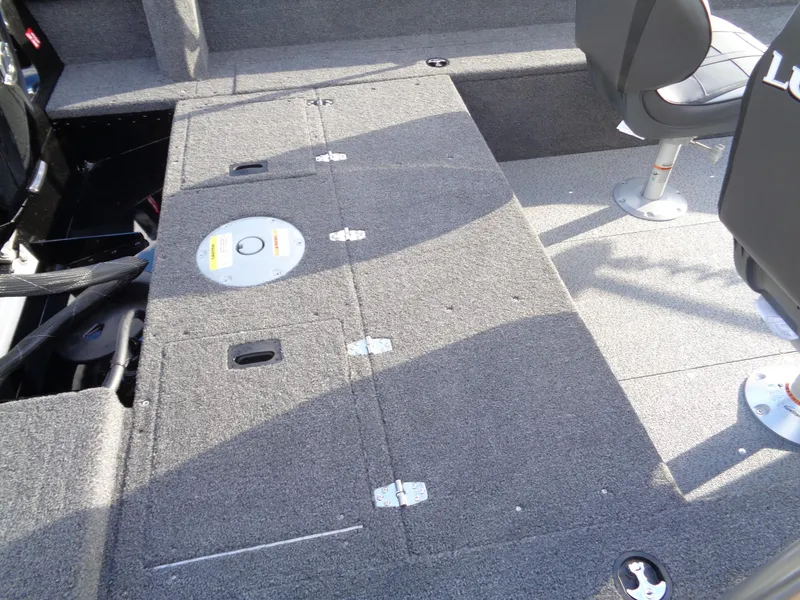 Slide: The Image of 2025 Lund 1650 Rebel XL SS boat interior with seating and storage compartments. - 14