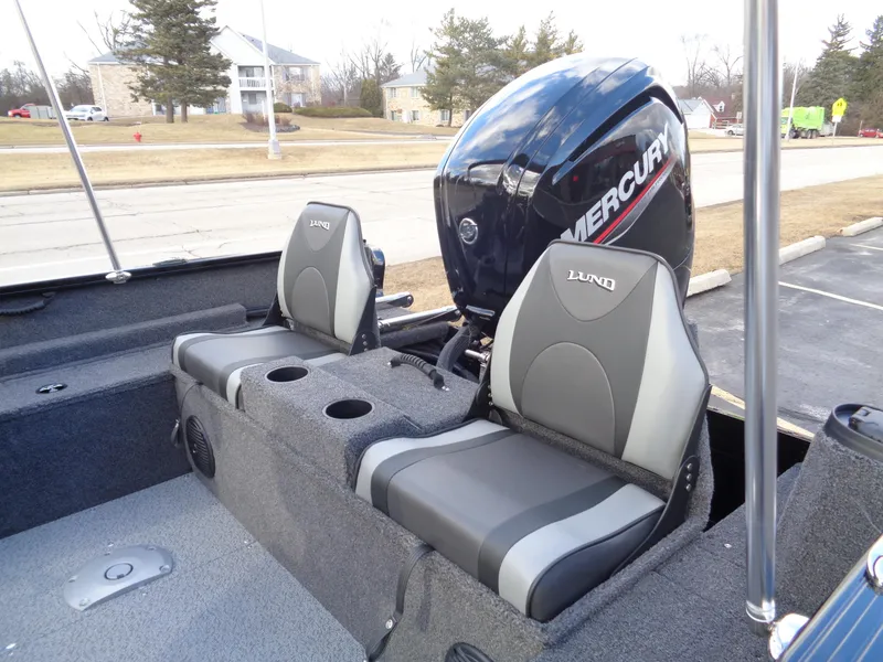 Slide: The Image of 2025 Lund 1650 Rebel XL SS boat interior with Mercury engine and dual seats. - 17