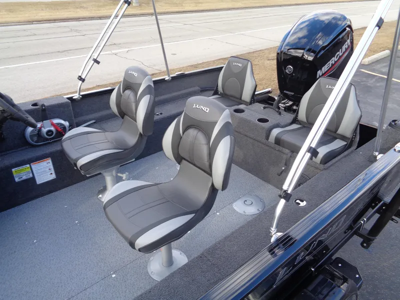 Slide: The Image of 2025 Lund 1650 Rebel XL SS boat interior with seating and Mercury outboard motor. - 19