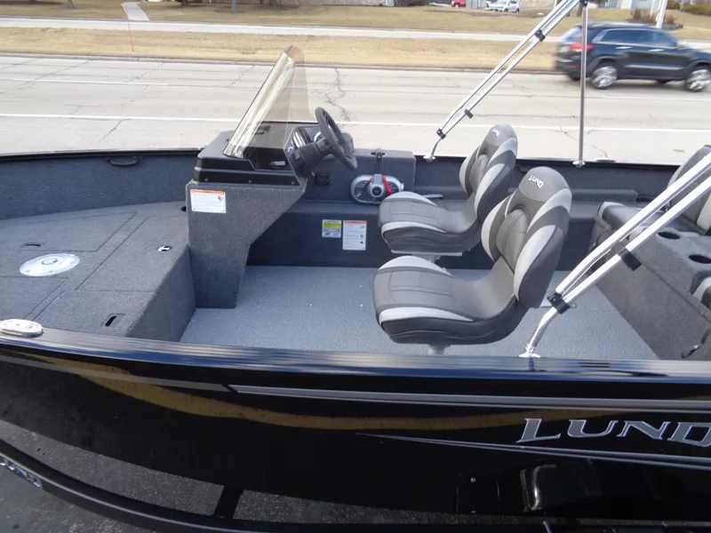 Slide: The Image of 2025 Lund 1650 Rebel XL SS boat interior with dual seats and steering console. - 20