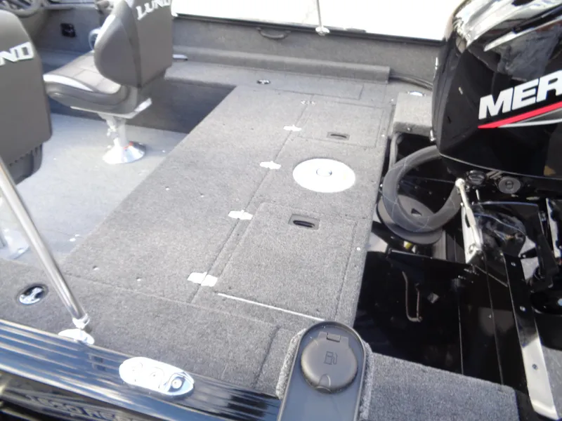 Slide: The Image of 2025 Lund 1650 Rebel XL SS boat interior with seating and Mercury engine. - 5