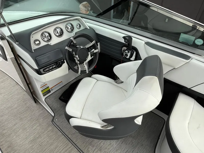 Slide: The Image of 2016 Regal 2300 Bowrider cockpit with modern steering and dashboard controls. - 5