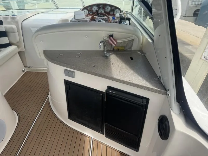 Slide: The Image of 2004 Rinker 342 Fiesta Vee boat interior with kitchenette and dashboard. - 10