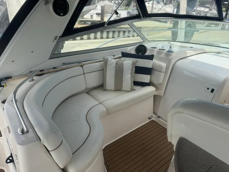 Slide: The Image of 2004 Rinker 342 Fiesta Vee boat interior with white seating and striped cushions. - 11