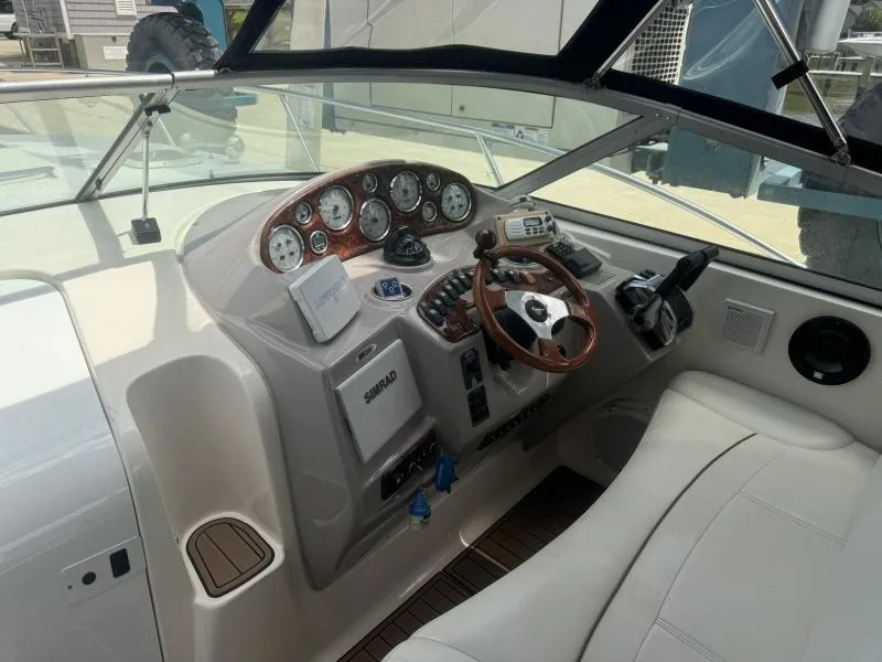 Slide: The Image of 2004 Rinker 342 Fiesta Vee boat cockpit with steering wheel and control panel. - 12