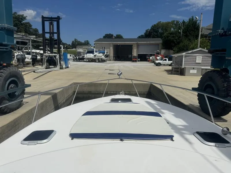 Slide: The Image of 2004 Rinker 342 Fiesta Vee boat in a marina with storage facilities. - 13
