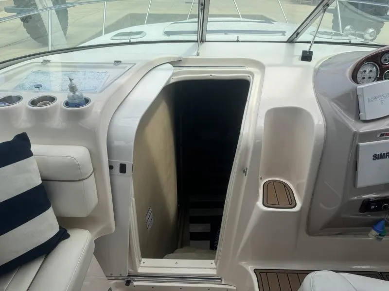 Slide: The Image of 2004 Rinker 342 Fiesta Vee boat interior with cabin entrance and dashboard view. - 14