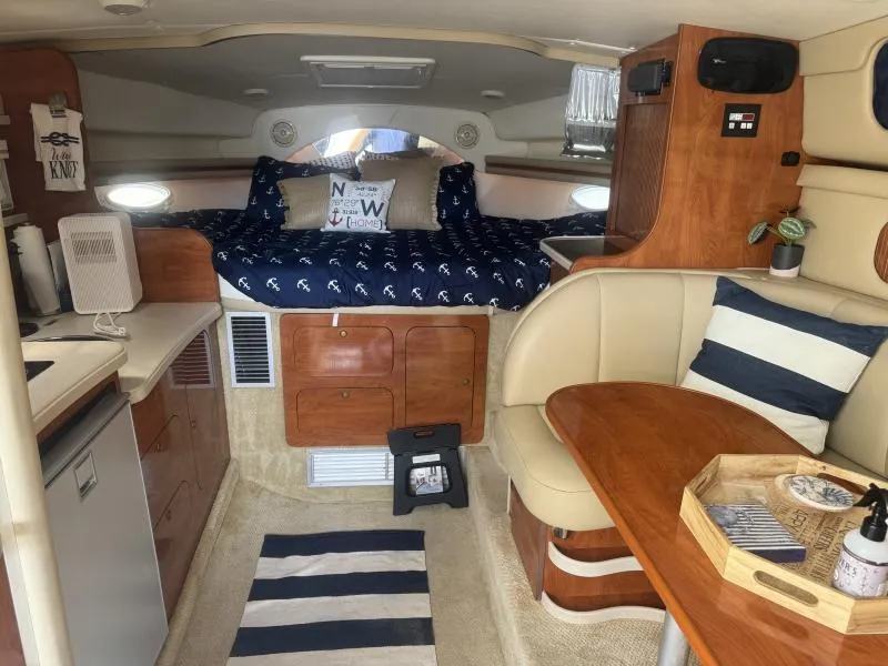 Slide: The Image of Interior of 2004 Rinker 342 Fiesta Vee boat with cozy cabin and nautical decor. - 15