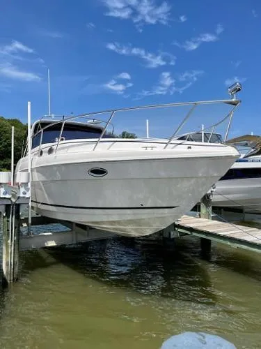 Slide: The Image of 2004 Rinker 342 Fiesta Vee boat docked, under a clear blue sky. - 2