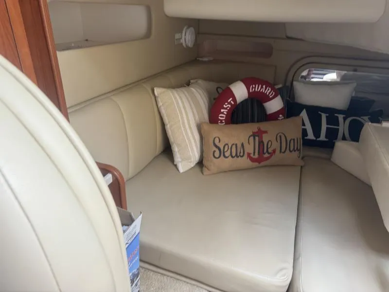 Slide: The Image of Cozy interior of 2004 Rinker 342 Fiesta Vee with nautical-themed pillows and decor. - 20