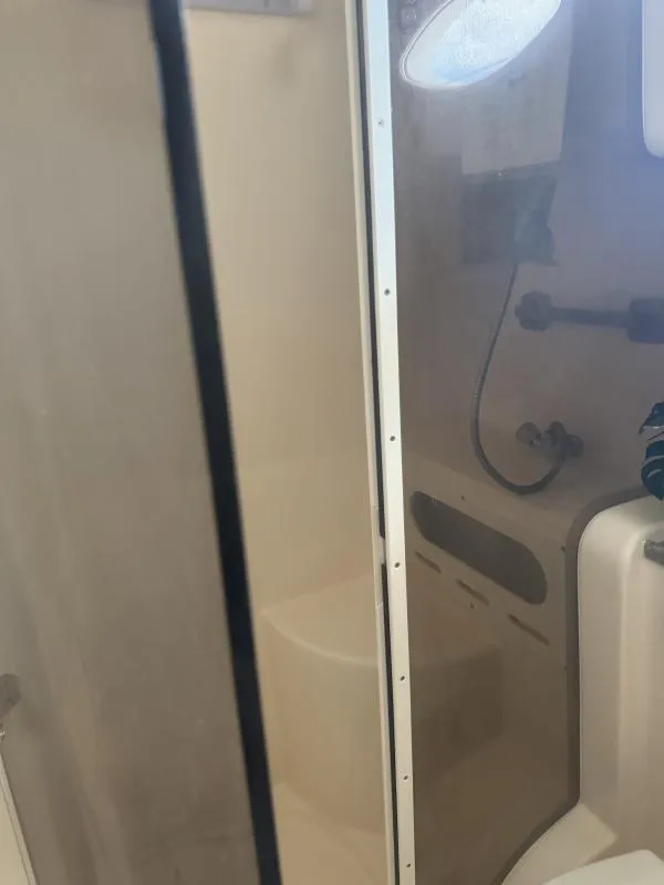 Slide: The Image of Interior of 2004 Rinker 342 Fiesta Vee boat bathroom with shower and fixtures. - 23