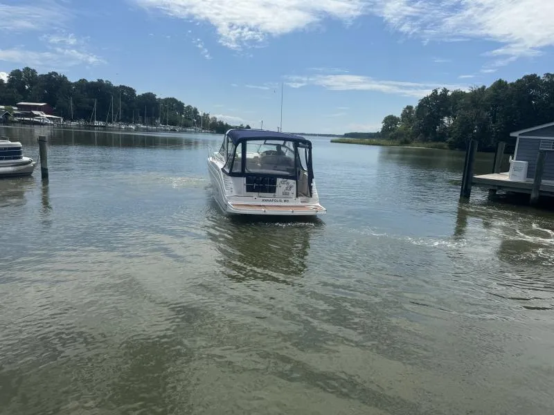 Slide: The Image of 2004 Rinker 342 Fiesta Vee boat cruising on a calm river under a clear sky. - 5