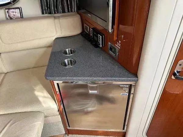 Slide: The Image of Interior of a 2012 Formula 350 SS boat with a kitchenette and seating area. - 13