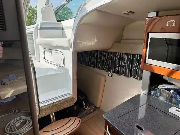 Slide: The Image of Interior of a 2012 Formula 350 SS boat, featuring a compact kitchen area. - 15