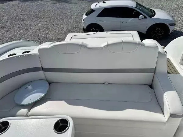 Slide: The Image of 2012 Formula 350 SS boat interior with white seating, cup holders, and a parked car nearby. - 4