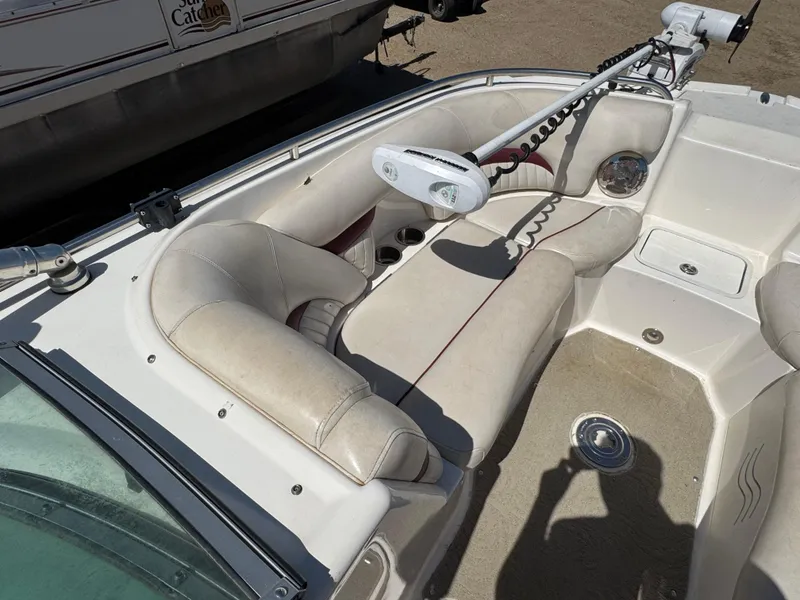Slide: The Image of 2008 Hurricane SunDeck 2400 IO boat interior with white captain's seat and steering wheel. - 12