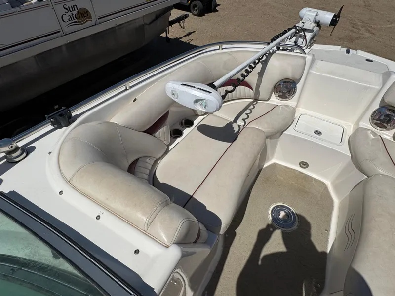 Slide: The Image of 2008 Hurricane SunDeck 2400 IO boat interior with white and maroon seating, cup holders visible. - 14